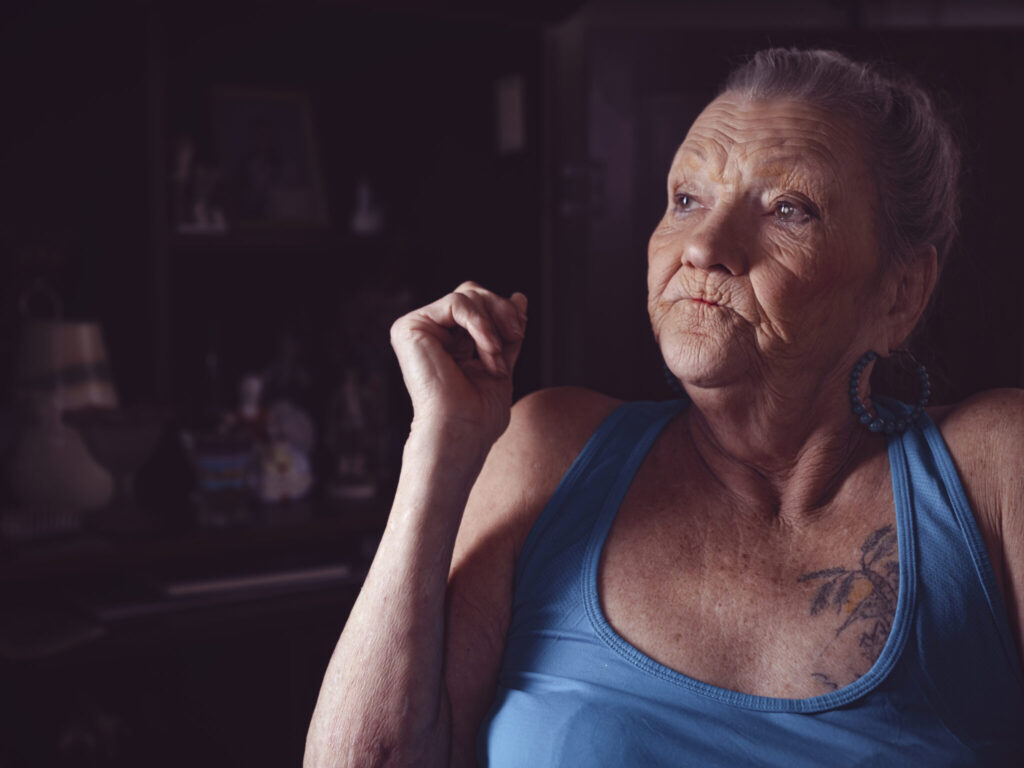 Mallie Luken, 70, remembers thinking of her parents as she tried to sleep outdoors in the parking lot of Abundant Life Church in Central City. She sat for a photo in her home in Greenville on April 27, 2025. (Kentucky Lantern photo by Austin Anthony)